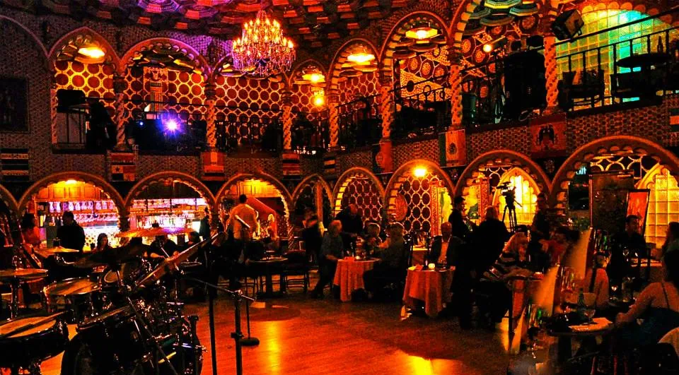 The ballroom bathed in red ambient light on a social night.