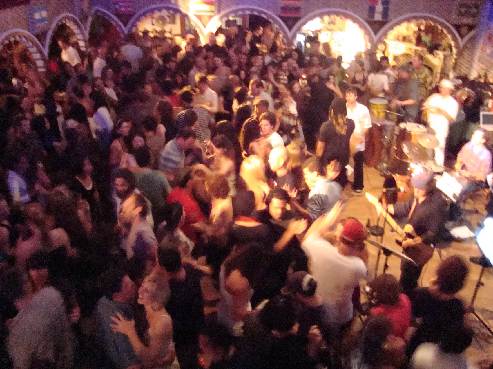 A full social dance floor, the room packed under the arches.