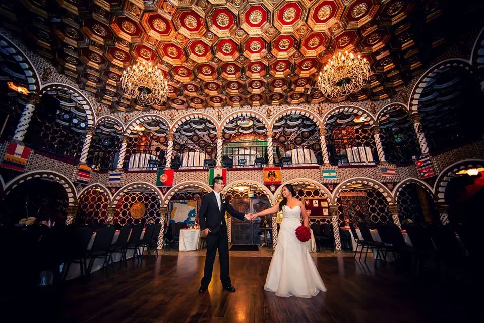 Dancers filling the floor under the glowing horseshoe arches.
