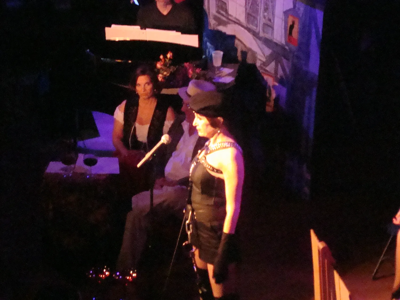 Two performers with a microphone on stage during a show.