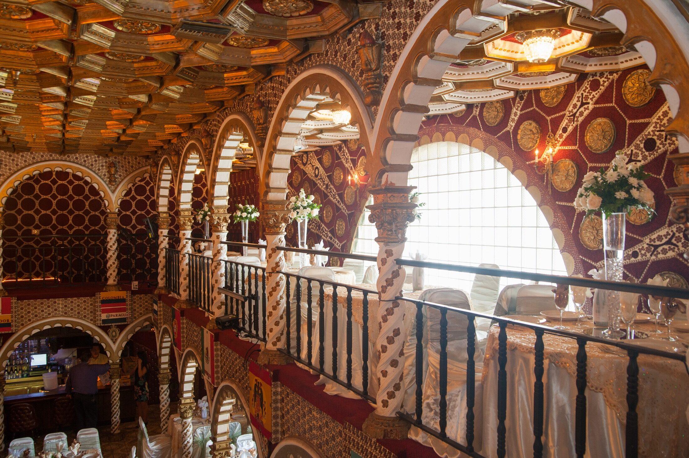 The upper-level Moorish arches and ornate honeycomb ceiling of the ballroom.