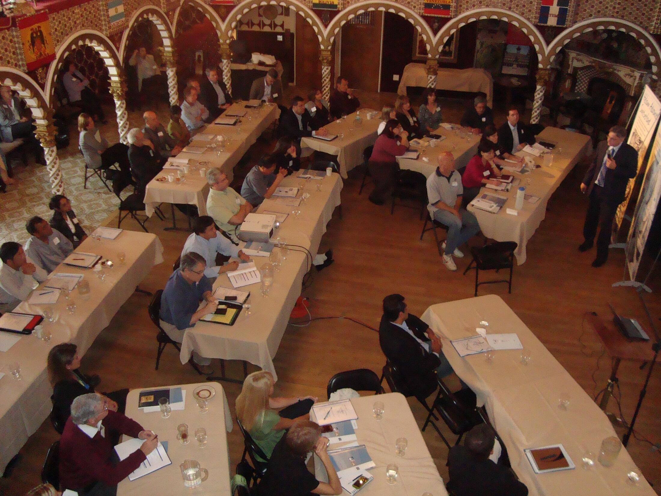 Guests seated at long banquet tables under the arches.