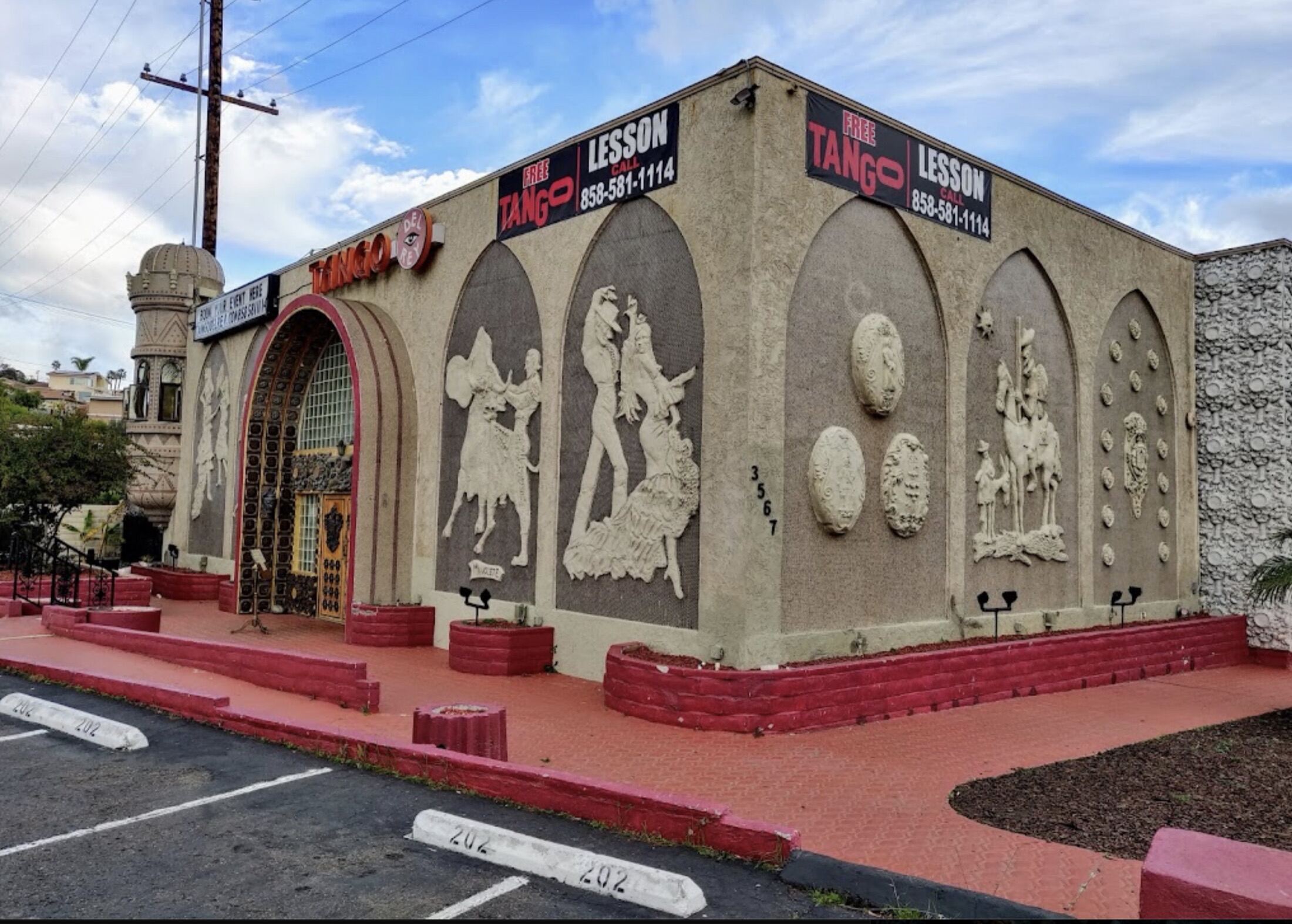 The Spanish-Moorish facade of Tango Del Rey with sculpted arches and relief figures of dancers.